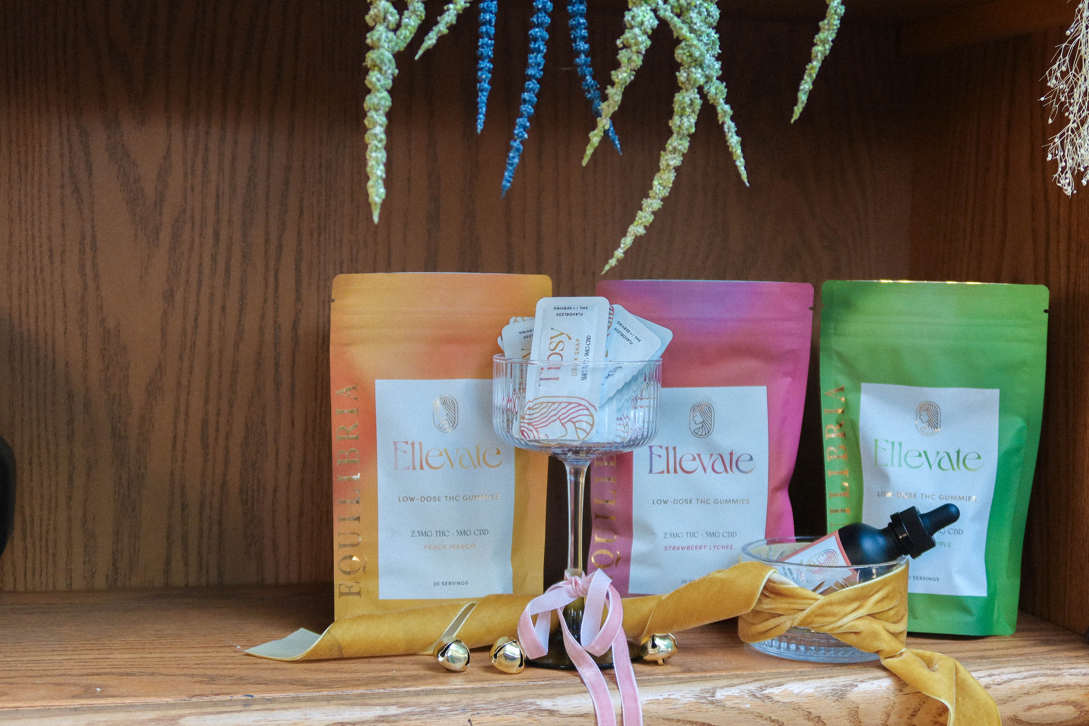 Ellevate THC Gummy Pouches Displayed Next to Drink Drops