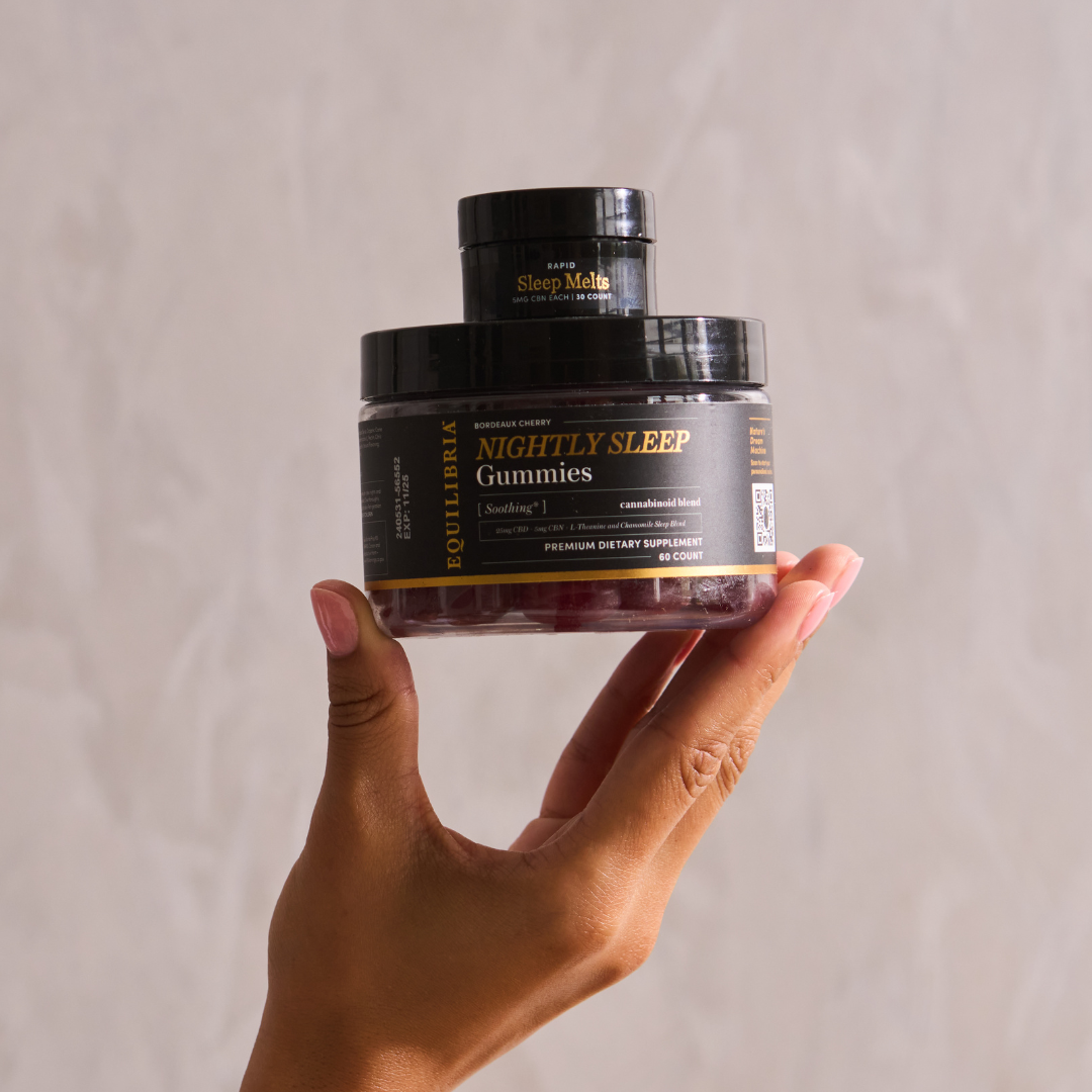 Equilibria Sleep Products stacked and held up with a right hand