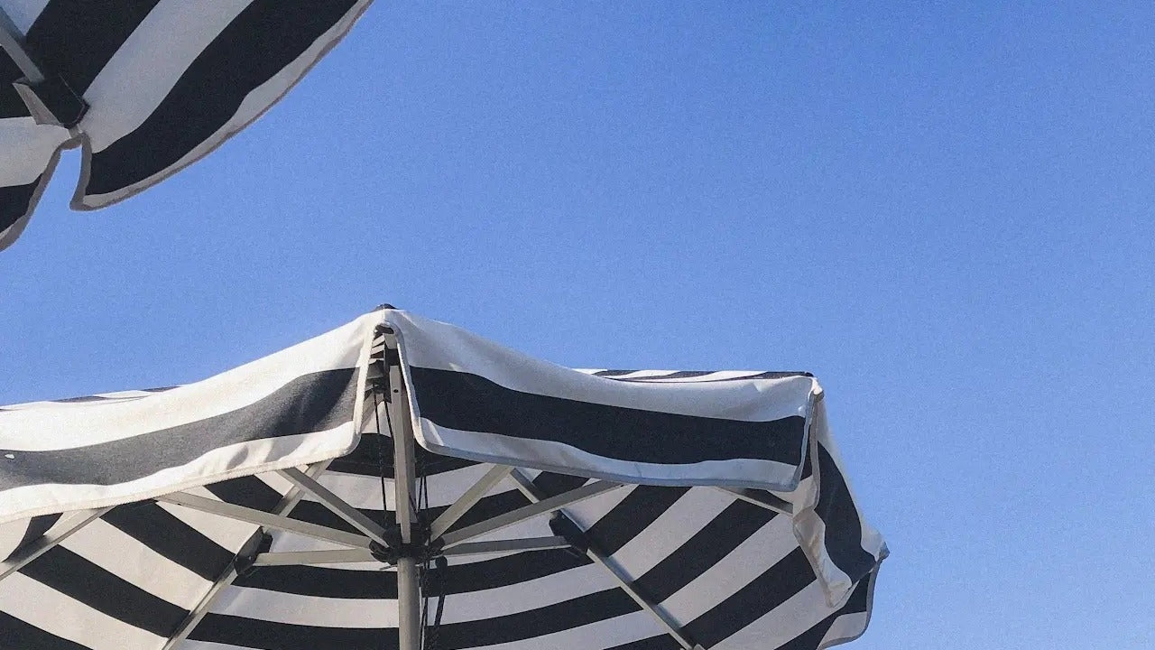Woman relaxing outdoors in summer sunlight — managing summer stress with CBD wellness support