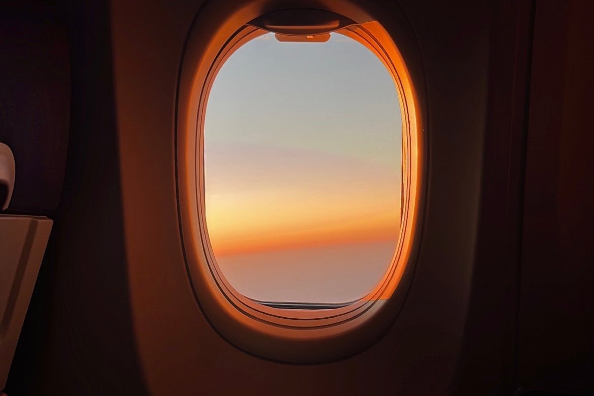 Traveling Picture Outside Airplane Window At Sunset