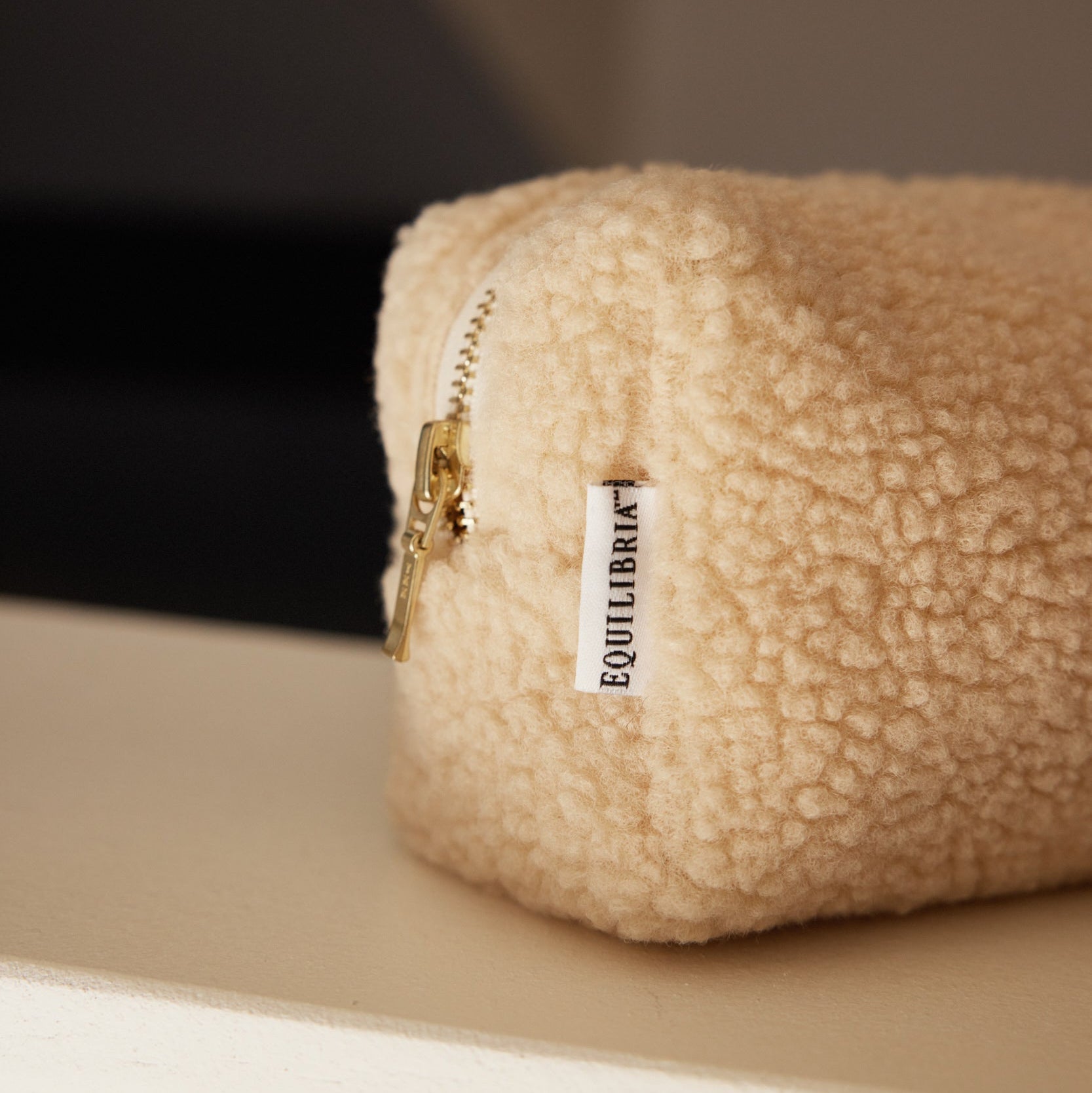 Small Ivory Zippered Pouch with Equilibria branded tag