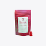 A stand-up pouch of Ellevate Equilibria low-dose THC gummies in strawberry lychee flavor, shown on a light gray background with three red gummies resting beside the package.