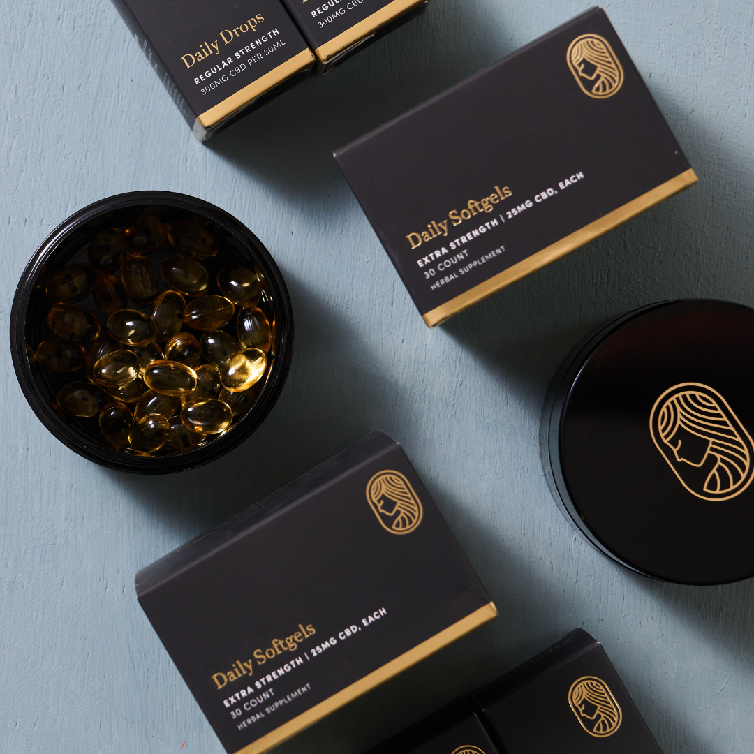 Product Display of Extra Strength Softgels in Black Jar and Black packaging on light blue background