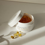 Jar of daily high quality CBD softgels with open lid on a light background