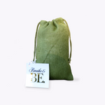 Green drawstring bag with a card labeled 'Breathe & BE' on a white background