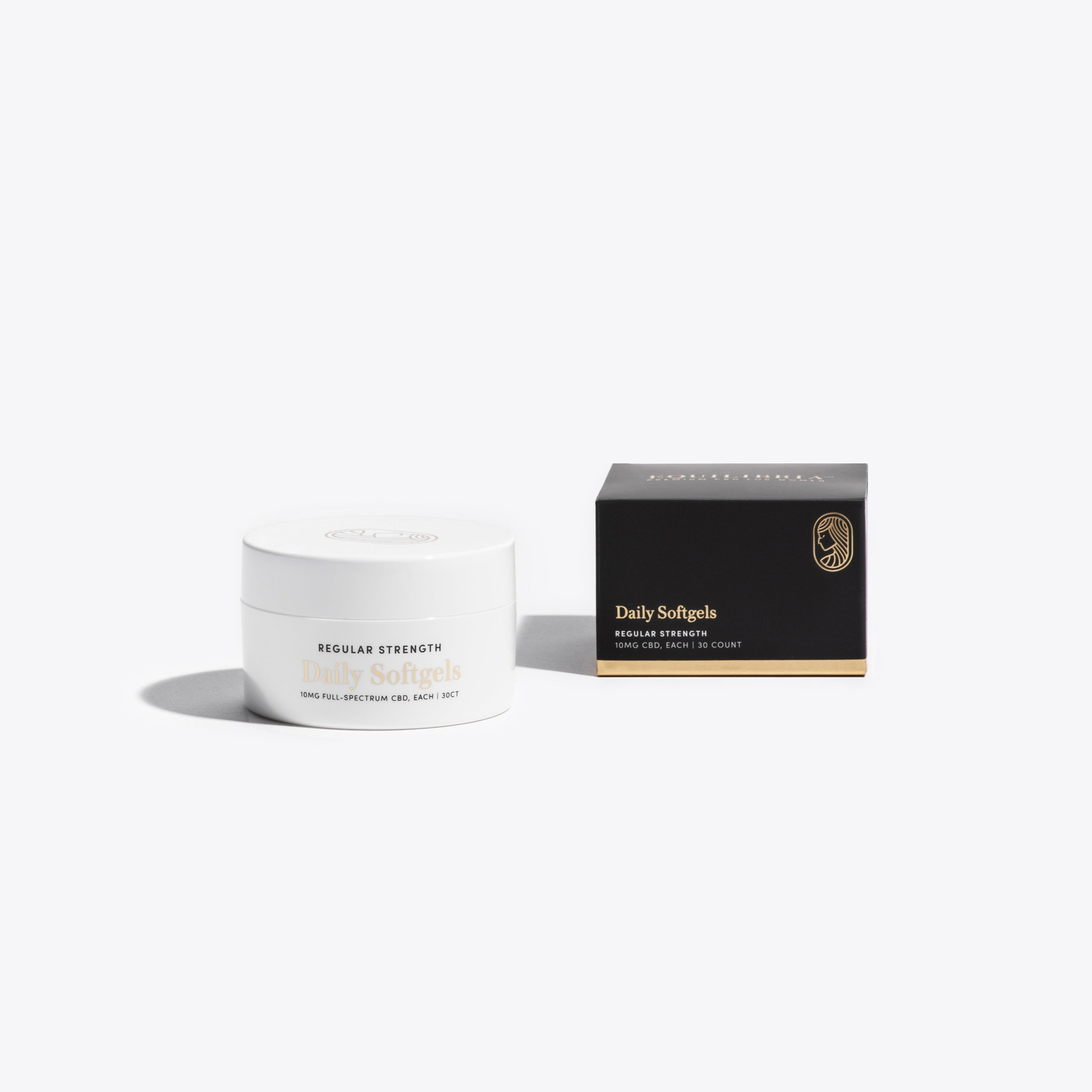 White jar of Equilibria Daily Softgels and black box packaging with gold text on a white background