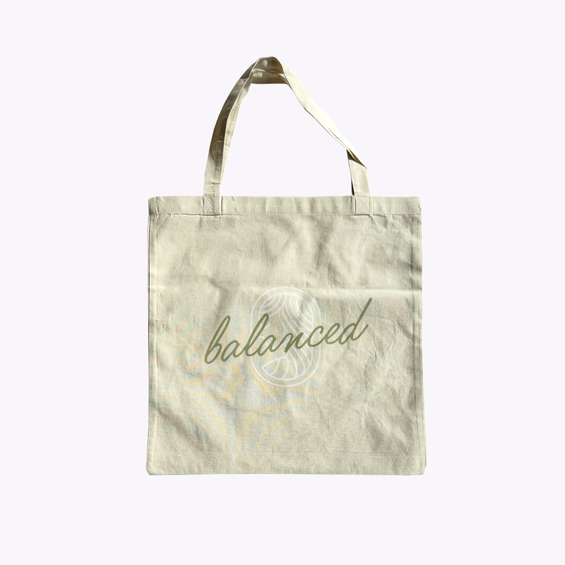 Tote bag with 'balanced' text with the Equilibria Goddess on a light background