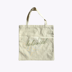 Tote bag with 'balanced' text with the Equilibria Goddess on a light background