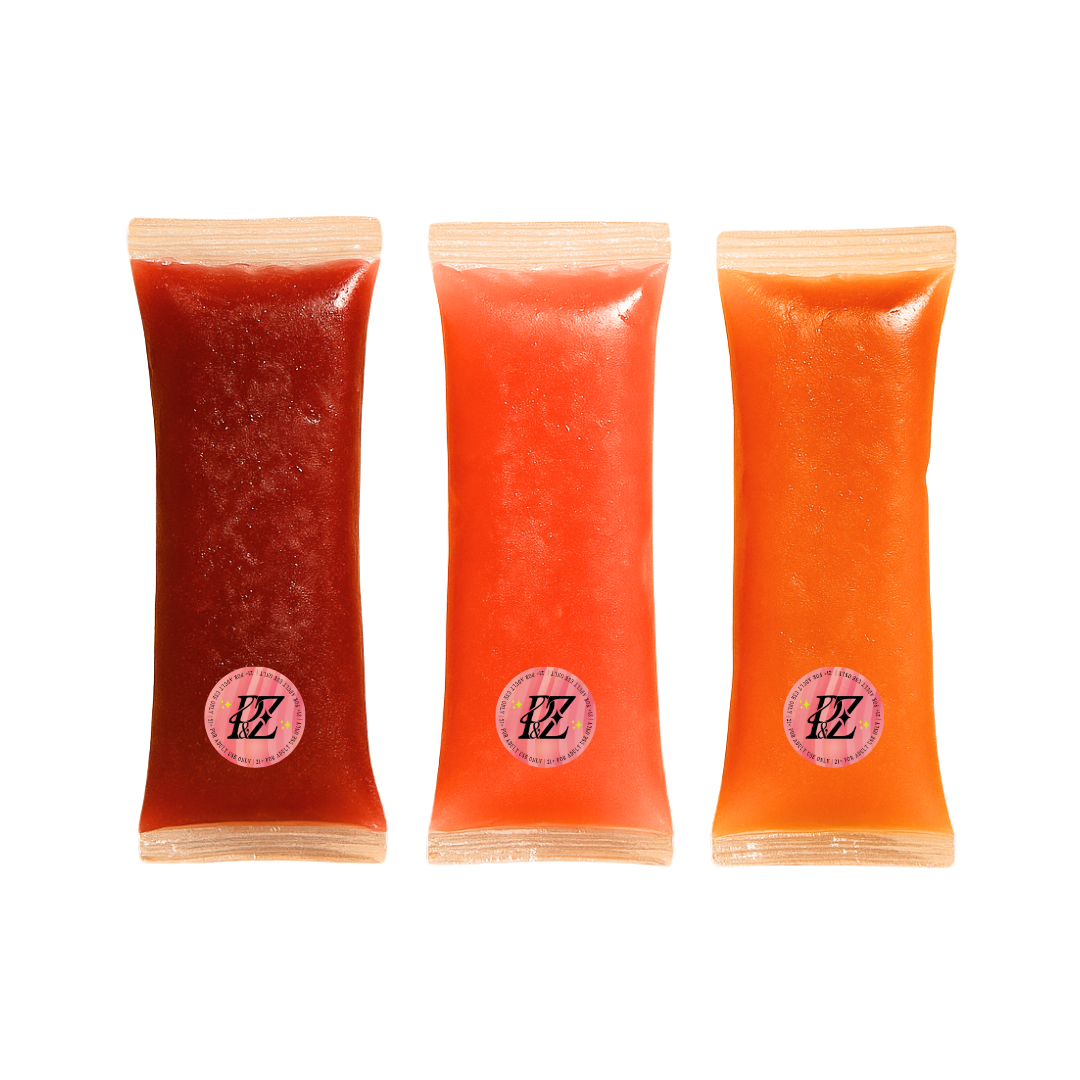 Three packages of red and orange freeze pop products with a 'Pixie & Zazz' brand logo on a white background